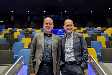 Speakers stood in front of cinema seating