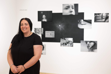 Woman standing infront of photographs