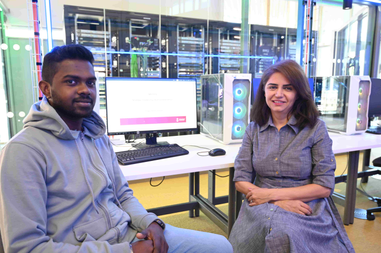 student and academic sat in front of a computer