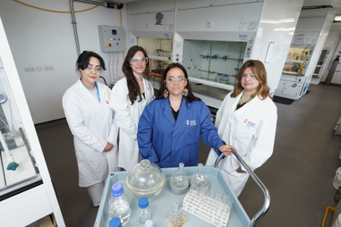 Four women standing in a laboratory