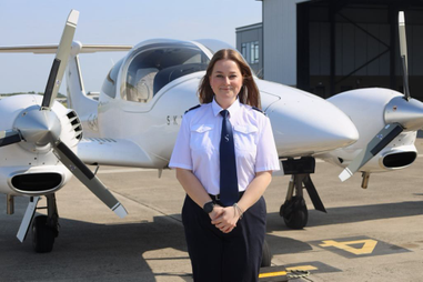 Woman standing infront of a plane