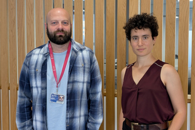 Member of staff stood with a journalist