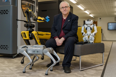 John Murray with robots at the University