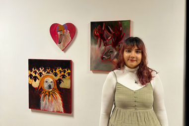 Student stood in front of her artwork