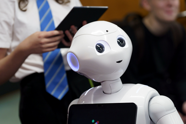 Robot stood in front of a student