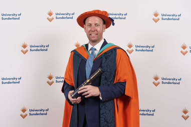 Honorary graduate in cap and gown