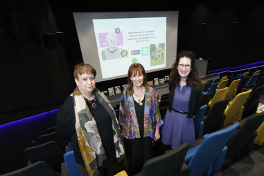 Academics and artist stood in cinema