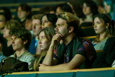 Students in lecture hall watching a film