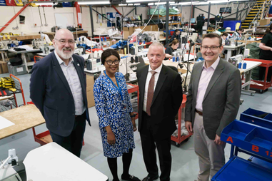 University staff stood in a factory