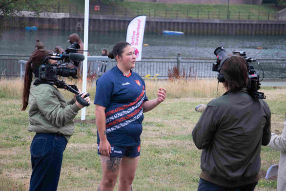 Woman being filmed by TV cameras