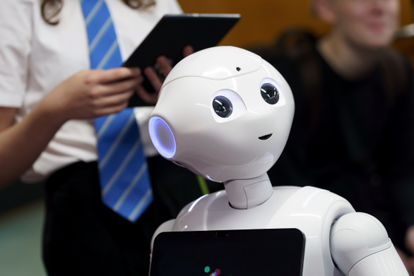 Robot stood in front of a student
