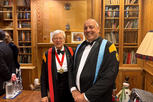 Graduate stood with official in ceremonial robes