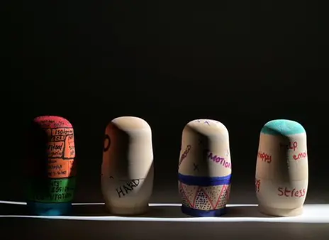 Russian dolls in a row in a dark background