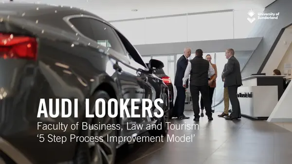 Group of people in an Audi showroom with a car in the forefront