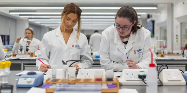 Two biomedical science students carrying out a practical in the lab