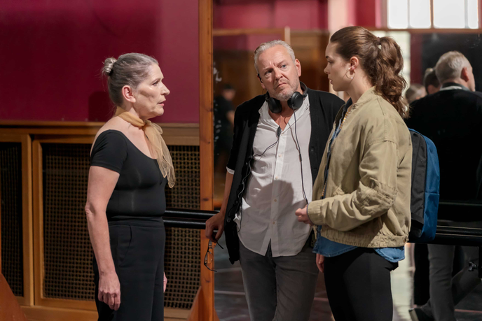 director and producer working with actors on set