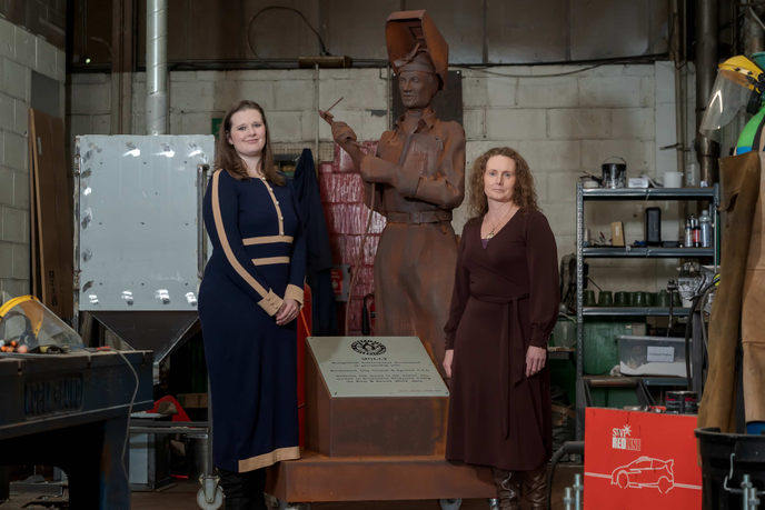Researchers standing beside the Molly sculpture