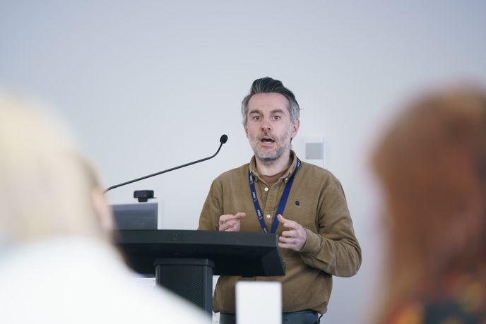 Man speaking on a podium