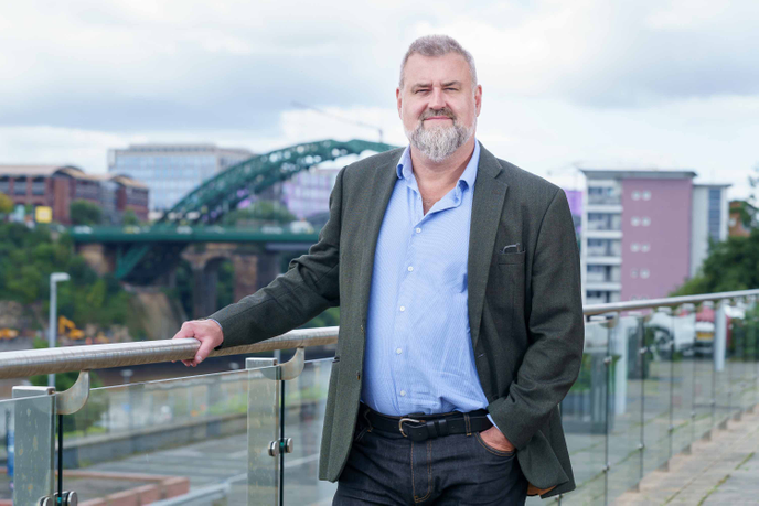 Academic stood in front of Sunderland landscape