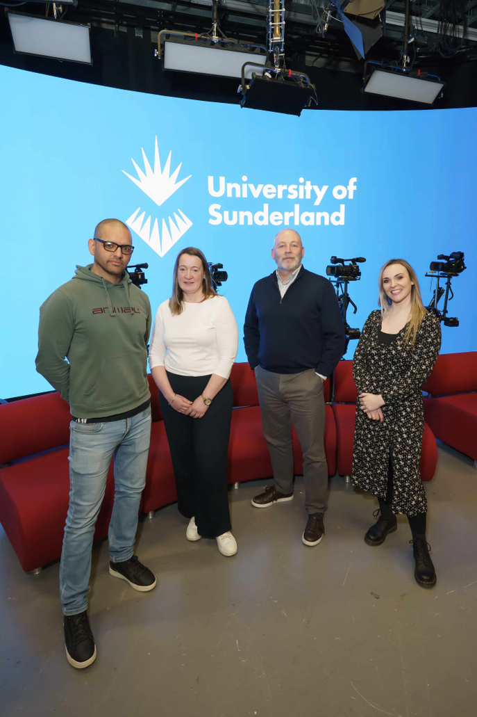Group of people standing in TV studio