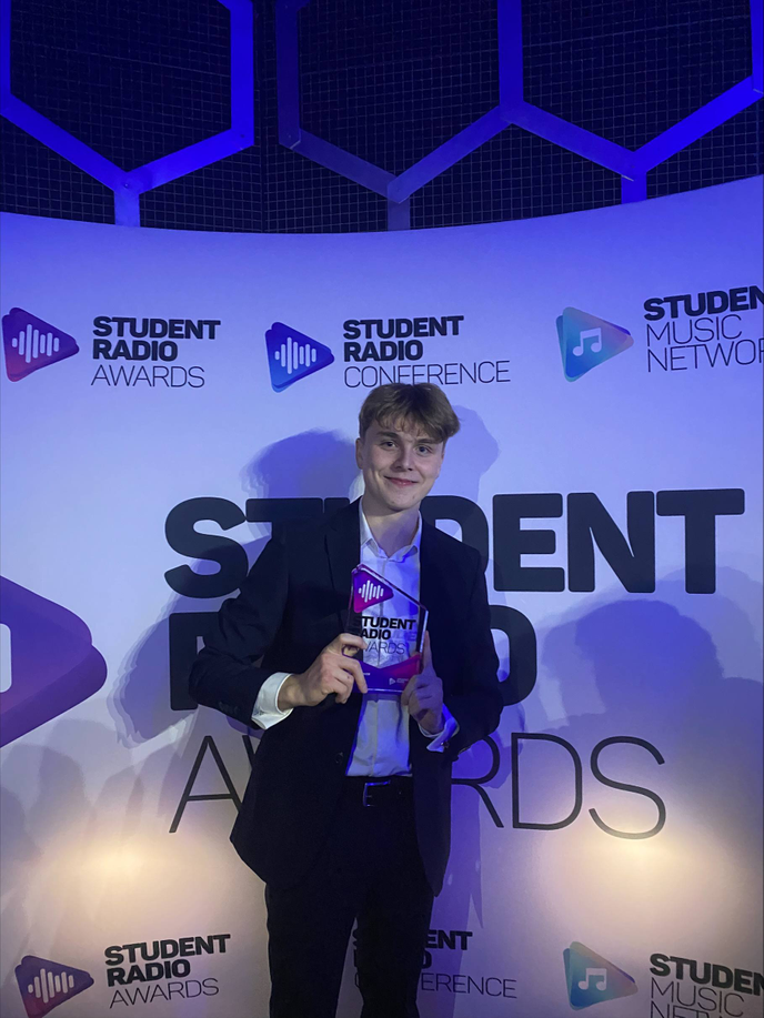 Student holding award