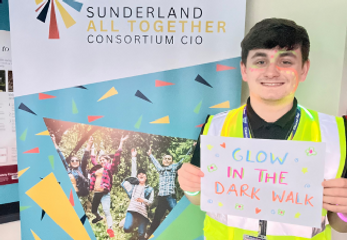 Student holding colourful poster