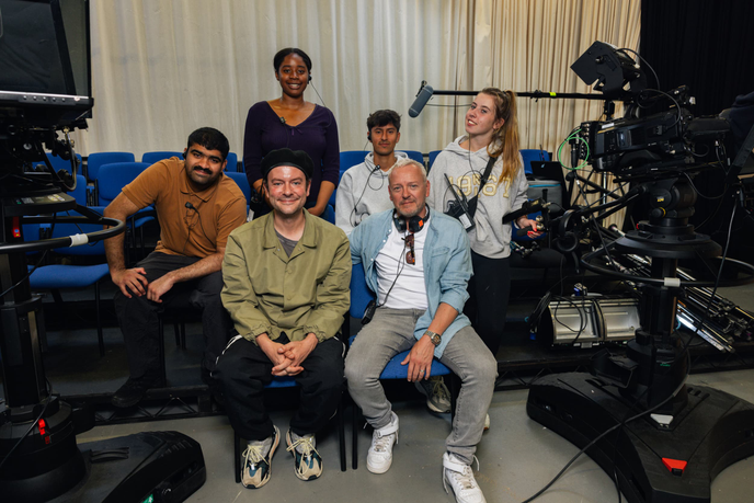 Group of people sitting in a TV studio