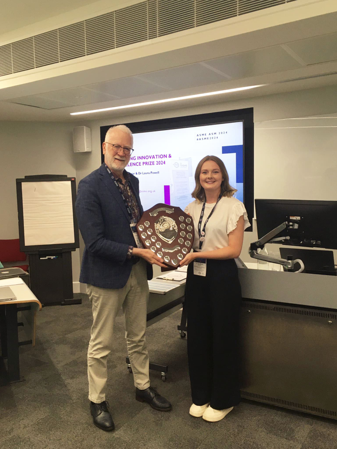 TASME Committee Chair Dr Bob McKinley and Dr Leah Williams holding the prize