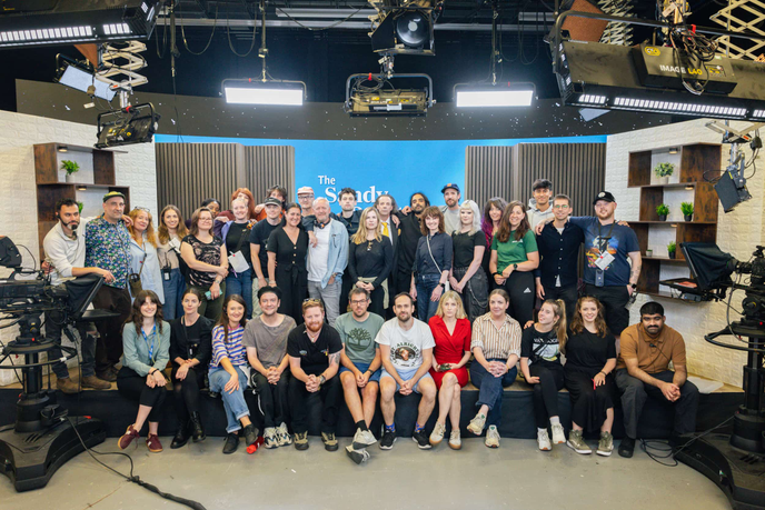 A large group of people in a TV studio
