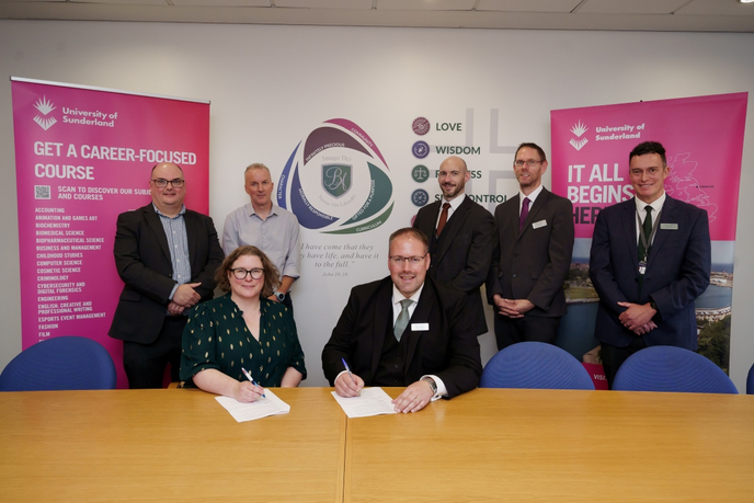 Academics signing an agreement