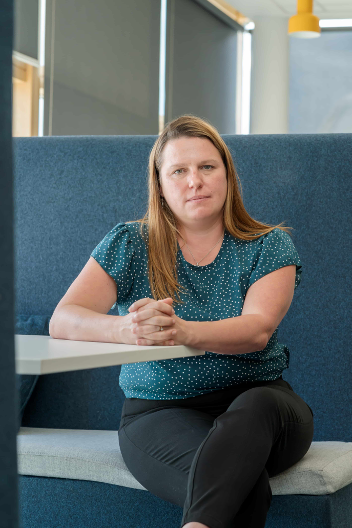 Dr Louise Harvey-Golding sitting with her arms resting on a table