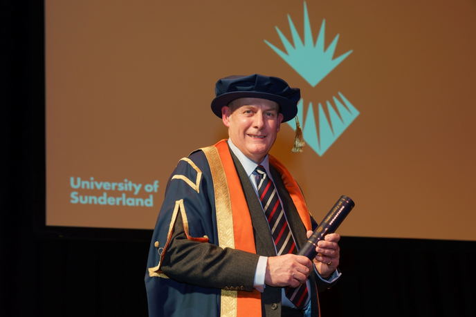 Trustee chair stood in ceremonial gowns