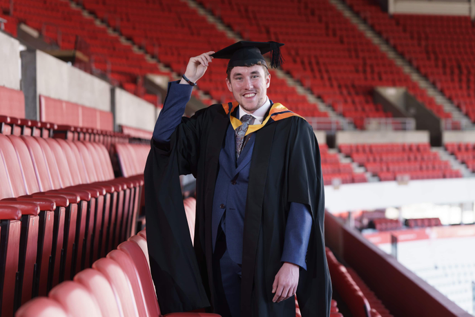 Graduate standing in a football stadium