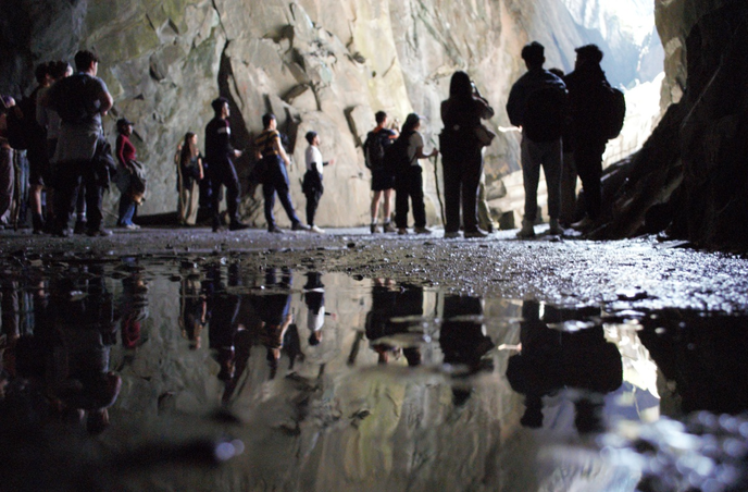 Students walking in a cave