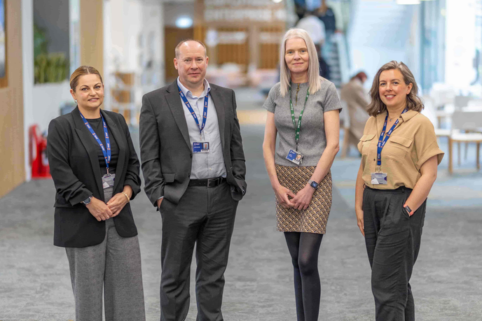 Four staff members stood together