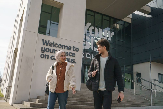 Two students talking in campus