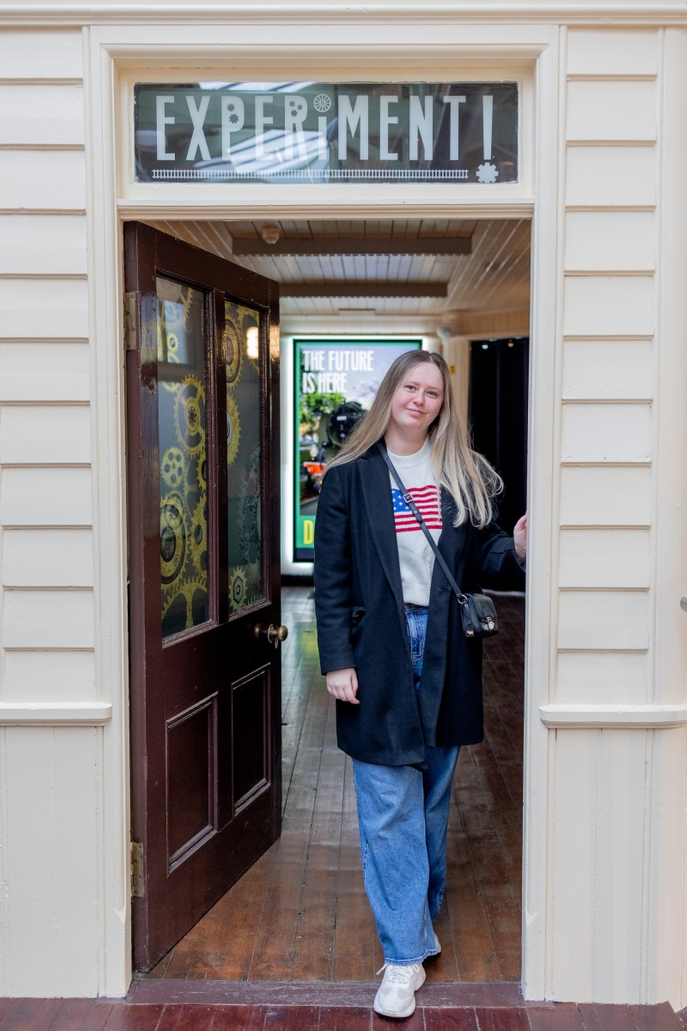 Graduate stood in door frame