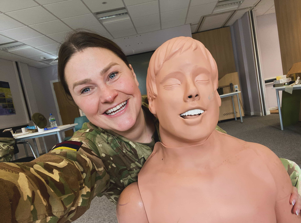 Student in uniform with a dummy