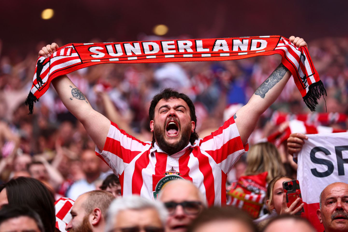Fan holding football scarf