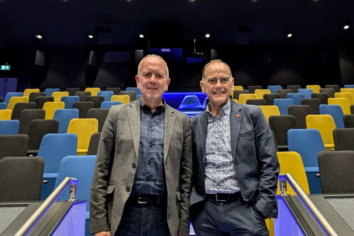 Speakers stood in front of cinema seating