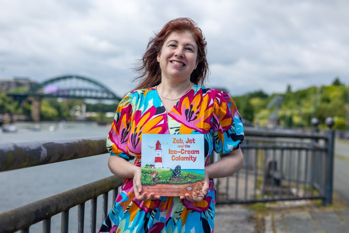 Mirabel holding children's book