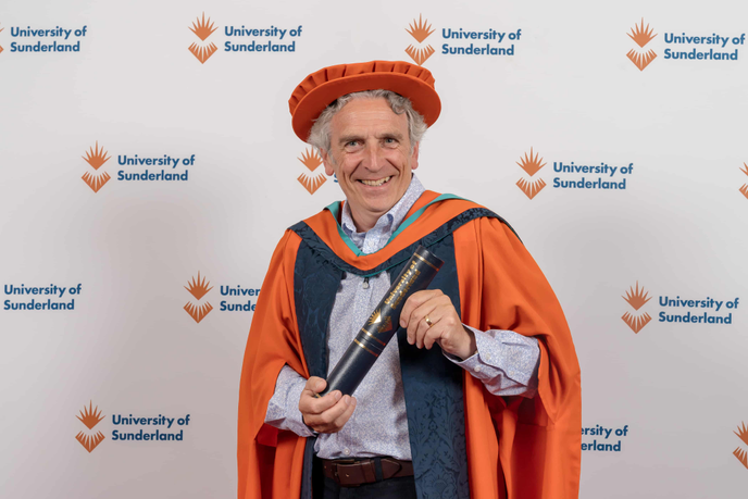 Richard O'Neill in graduation gown and cap