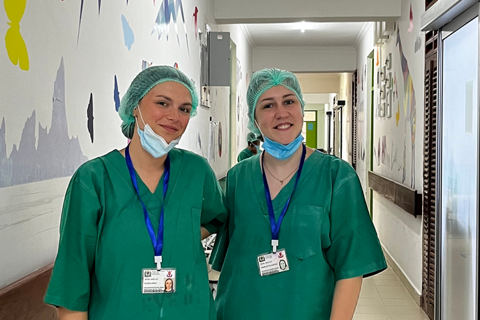 Students in medical scrubs in a hospital