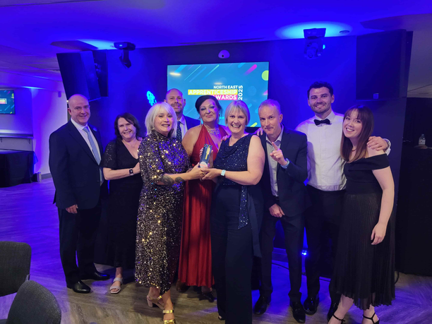 University staff holding award