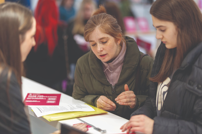 Student reading leaflets