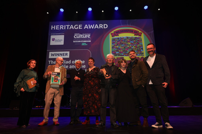 People accepting an award on stage