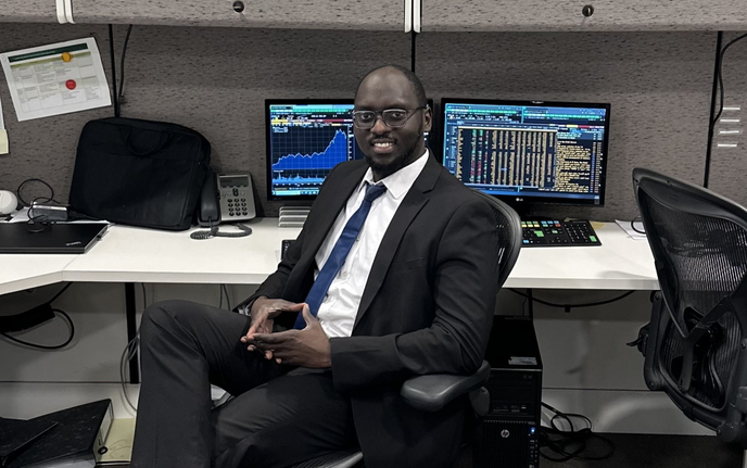 Abdalla sitting infront of computer screens