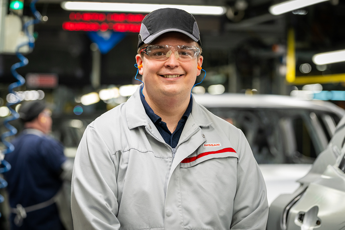 Apprentice stood in car factory