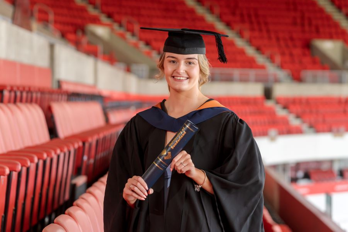 Claire Bebb standing at graduations