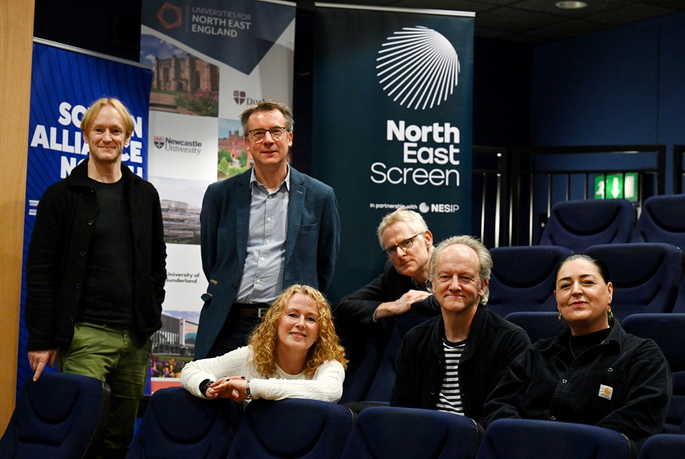 University academics sat in seats for pictures
